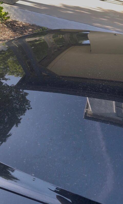 Dirty car hood with dust and grime before an exterior hand wash
